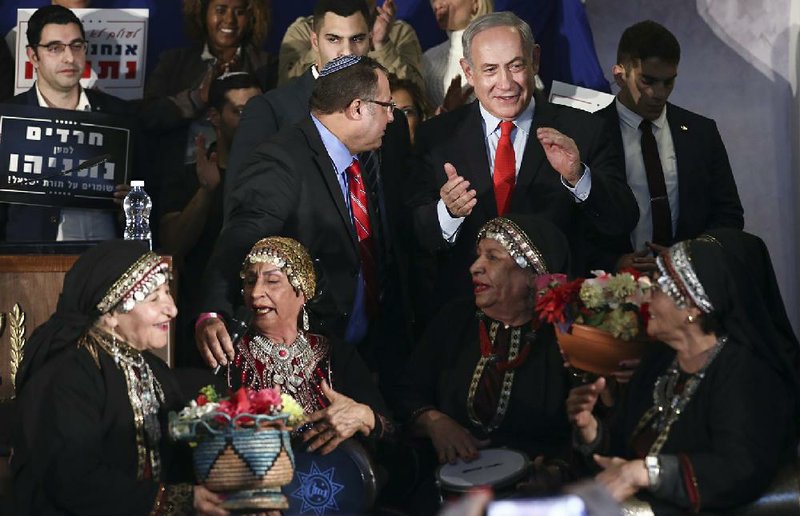 Supporters welcome Israeli Prime Minister Benjamin Netanyahu (center) to a campaign event Thursday in Rosh Haain, Israel. Netanyahu faces Benny Gantz in a March 2 election as Israelis continue to try to form a government. Meanwhile, Secretary of State Mike Pompeo said Thursday that he is “outraged” by the U.N. publication of a list of companies accused of violating Palestinian human rights by operating in Israel’s West Bank settlements. More photos at arkansasonline.com/214israel/.
(AP/Oded Balilty)