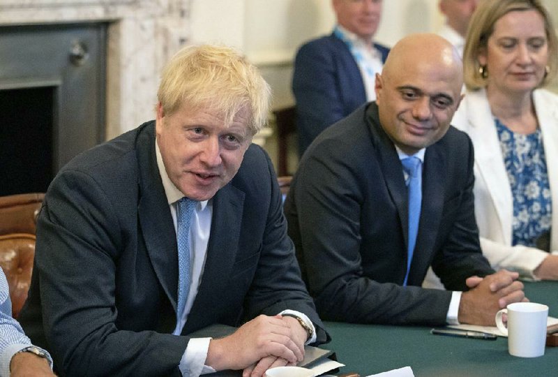 In this Thursday July 25, 2019 file photo, Britain's Prime Minister Boris Johnson, left, holds his first Cabinet meeting, with Chancellor of the Exchequer Sajid Javid, center, at Downing Street in London. 
 (Aaron Chown/Pool via AP, file)