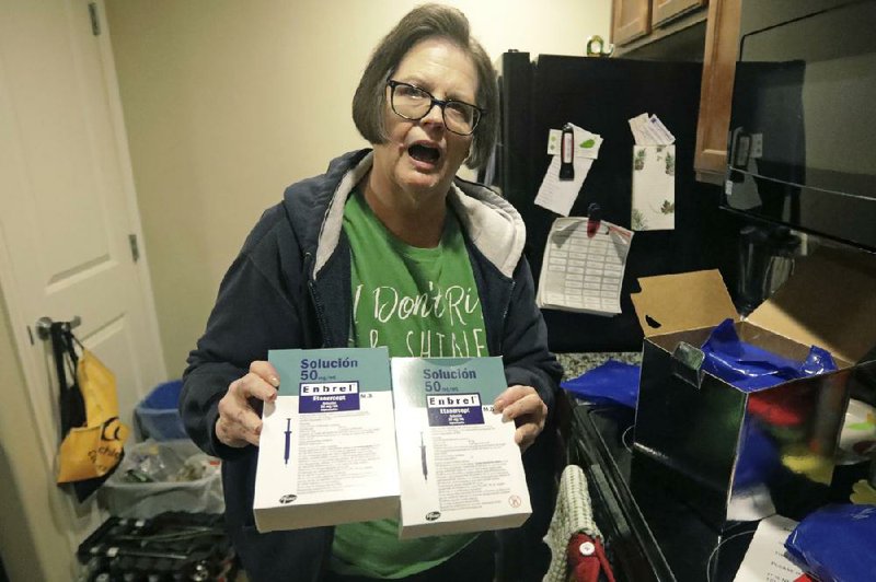 Utah resident Ann Lovell holds arthritis drug prescriptions last month that she filled in Tijuana, Mexico. A White House economic advisory panel report says other countries’ drug-purchasing programs result in lower drug costs that put buyers in the U.S. free-market system at a disadvantage.
(AP/Rick Bowmer)
