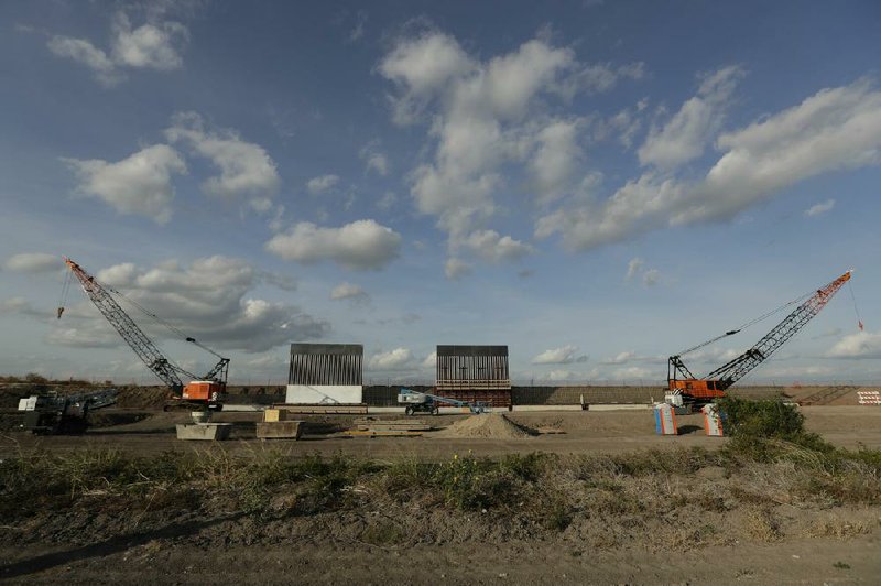 The first panels of a section of wall go up on the U.S.-Mexico border in Donna, Texas, in November. The Pentagon informed Congress on Thursday of plans to divert $3.83 billion from its budget to build more of the barrier, angering some in Congress.
(AP/Eric Gay)