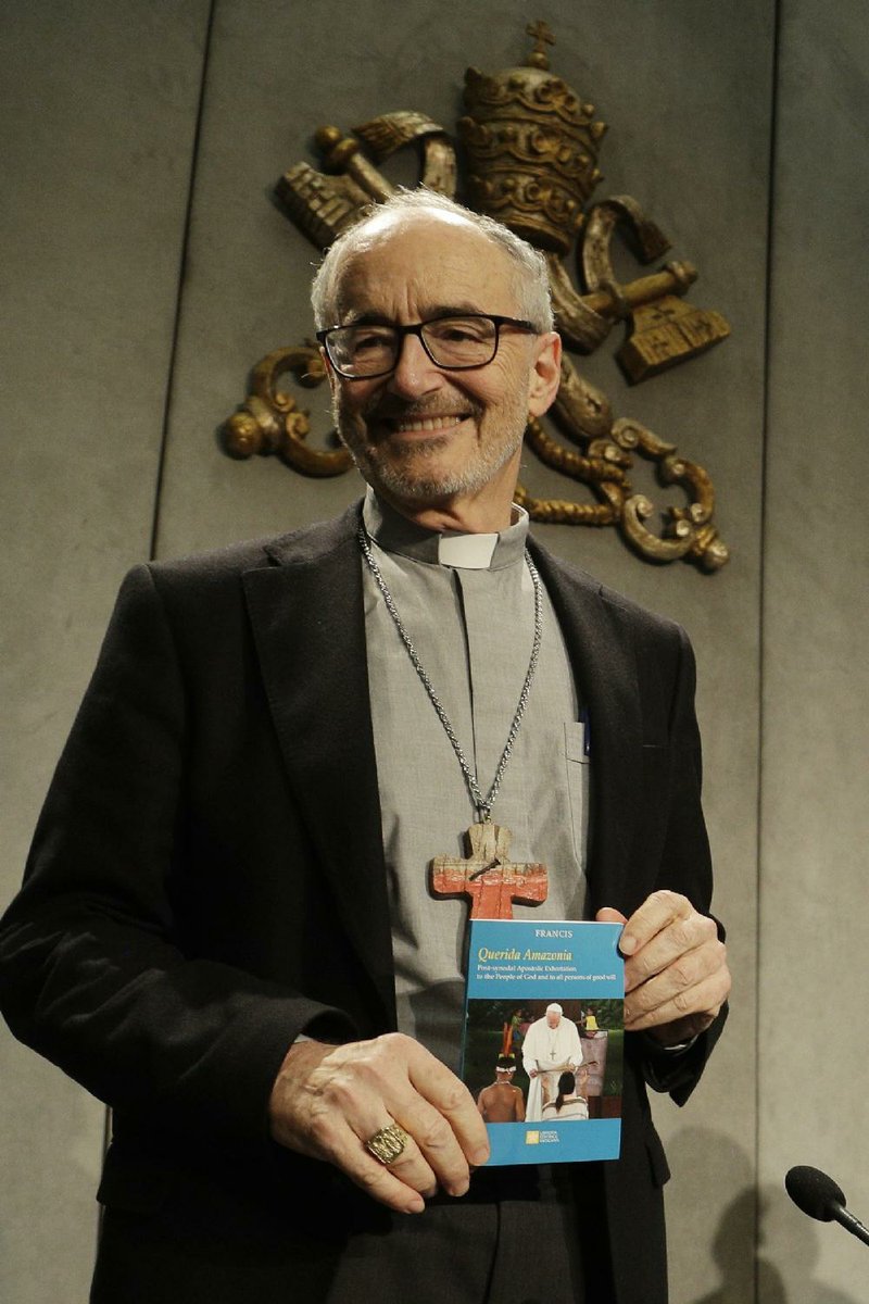 Cardinal Michael Czerny holds a copy of Pope Francis’ document, “Beloved Amazon,” during a news conference Wednesday at the Vatican. More photos at arkansasonline.com/214pope/.
(AP/Gregorio Borgia)