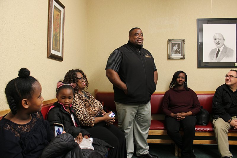 The Sentinel-Record/Tanner Newton FROM THE HEART: Hot Springs assistant football coach and local restaurant owner Courtney Sanders, center, addresses the local NAACP chapter on Saturday at the Webb Community Center. He was joined by his daughters, Courtland Sanders, left, and Layla Sanders, his mother, Teresa Hamilton, and his wife Veronica Sanders, right.