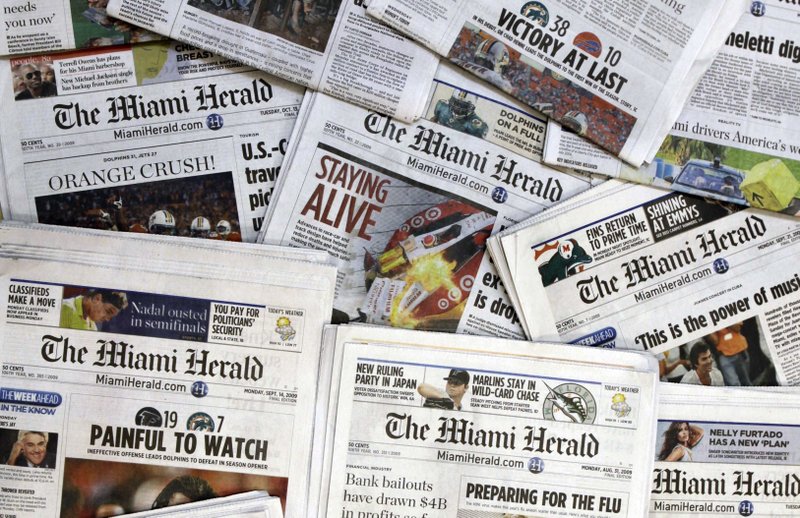 FILE - This Oct. 14, 2009 file photo, shows copies of the McClatchy Co. owned Miami Herald newspaper in Miami. McClatchy Co., the publisher of the Miami Herald, The Kansas City Star and dozens of other newspapers across the country is filing for bankruptcy protection. McClatchy Co. said Thursday, Feb. 13, 2020, that it will continue to run normally as it pursues approval of its restructuring plan under Chapter 11.  (AP Photo/Wilfredo Lee, File)