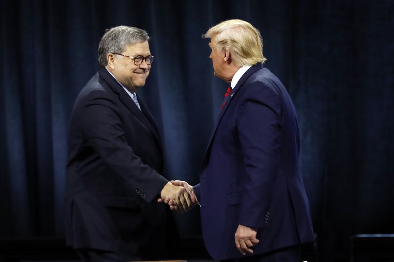 In this Oct. 28, 2019, file photo, President Donald Trump shakes hands with Attorney General William Barr. (AP Photo/Charles Rex Arbogast, File)