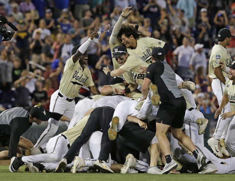 FILE - In this June 26, 2019, file photo, Vanderbilt players celebrate after defeating Michigan to win Game 3 of the NCAA College World Series baseball finals in Omaha, Neb. The Commodores won their second national championship since 2014, beating Michigan in the College World Series finals. Vanderbilt's 59 wins set a Southeastern Conference record. (AP Photo/Nati Harnik, File) story.lead_photo.caption