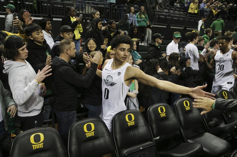 Oregon's Will Richardson, center, celebrates with fans after helping his team defeat Colorado 68-60 in Thursday's game in Eugene, Ore. - Photo by Chris Pietsch of The Associated Press story.lead_photo.caption
