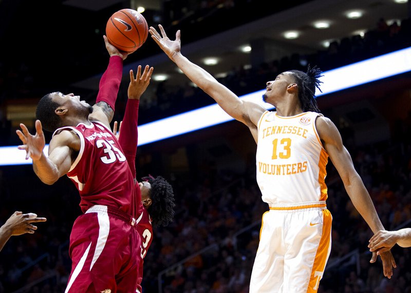 Arkansas forward Reggie Chaney (35) and Tennessee guard Jalen Johnson (13) reach for the rebound during an NCAA college basketball game, Tuesday, Feb. 11, 2020 in Knoxville, Tenn. (Brianna Paciorka/Knoxville News Sentinel via AP) story.lead_photo.caption