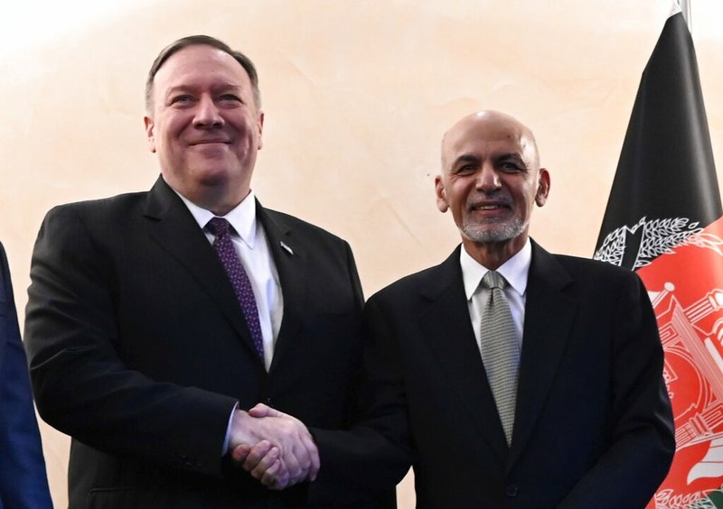 U.S. Secretary of State Mike Pompeo, left, shakes hands with Afghan President Ashraf Ghani,during the 56th Munich Security Conference (MSC) in Munich, southern Germany, on Friday, Feb. 14, 2020. The 2020 edition of the Munich Security Conference (MSC) takes place from Feb. 14 to 16. (Andrew Caballero-Reynolds/Pool photo via AP)