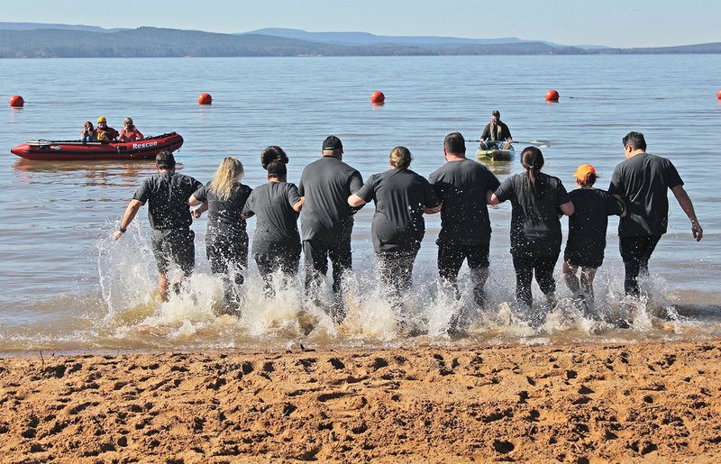 Members of Team Arkansas Nuclear One, with Entergy, link arms and brave the cold waters of Lake Dardanelle on Feb. 1 during the ninth annual Polar Plunge. See more photos at www.arkansasonline.com/galleries/categories/rivervalley/.