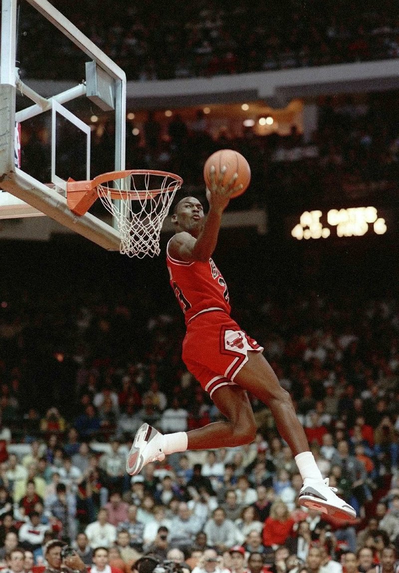 In this Feb. 6, 1988, file photo, Michael Jordan dunks during the NBA Slam Dunk contest at Chicago Stadium in Chicago. The Bulls guard won the contest, but Dominique Wilkins, who was with the Atlanta Hawks, believed he should have won.
(AP/John Swart)
