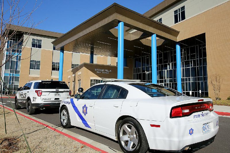 Arkansas State Police and Sylvan Hills police vehicles are parked outside Sylvan Hills High School, where there was a large police presence when the school reopened Friday.
(Arkansas Democrat-Gazette/Thomas Metthe)