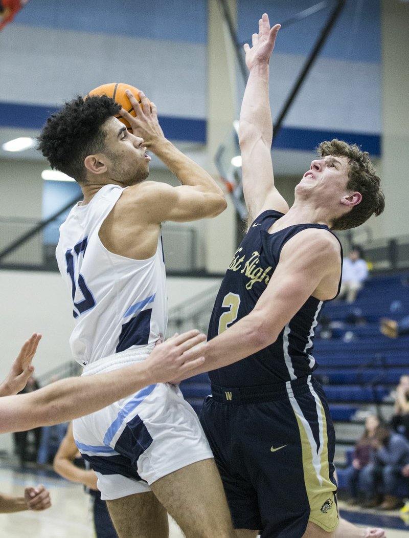 Nick Buchanan of Springdale Har-Ber shoots as Dillon Bailey of Bentonville West defends Friday, Feb. 14, 2020, at Wildcat Arena in Springdale. Go to nwaonline.com/prepbball/ to see more photos. (NWA Democrat-Gazette/Ben Goff)