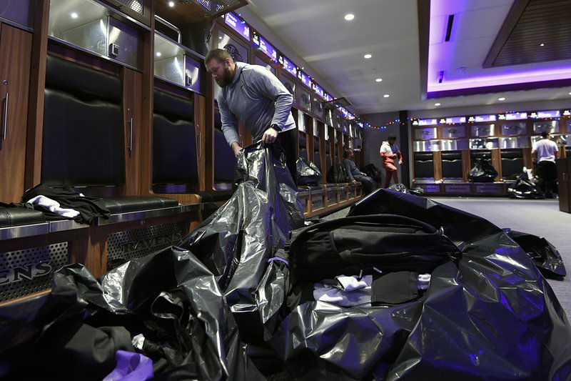 Baltimore Ravens guard James Hurst fills bags with items from his locker, Sunday, Jan. 12, 2020 in Owings Mills, MD. (AP Photo/Gail Burton)