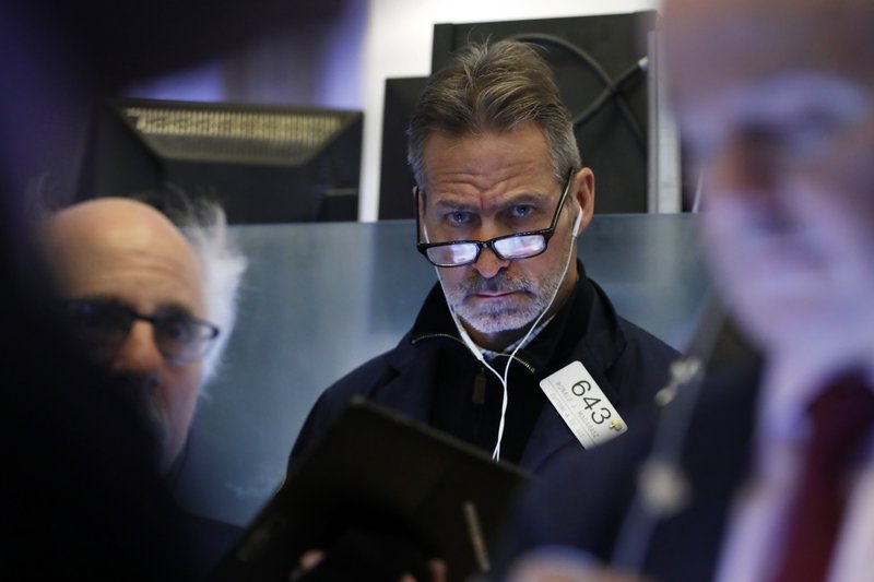 Trader Ronald Madarasz works on the floor of the New York Stock Exchange, Friday, Feb. 14, 2020. U.S. stocks wobbled between small gains and losses in early trading Friday as investors focused on another round of mostly solid corporate earnings. (AP Photo/Richard Drew)