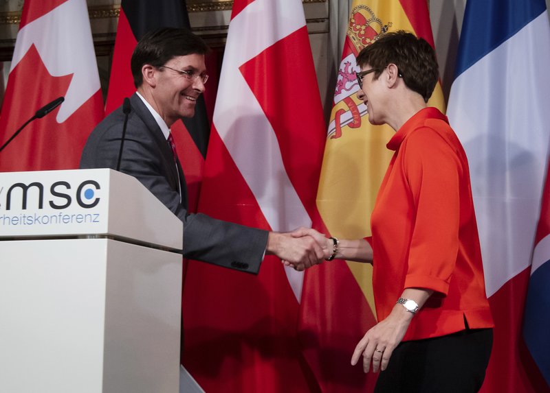 U.S. Secretary for Defense Mark Esper, left, and German defense minister Annegret Kramp-Karrenbauer shake hand after a press conference on the first day of the Munich Security Conference in Munich, Germany, Friday, Feb. 14, 2020. (Sven Hoppe/dpa via AP)