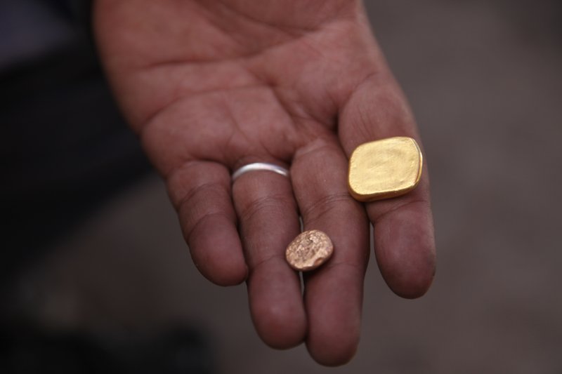 This photo taken on Monday Jan. 22, 2020 shows a gold miner holding gold in Kidal, Mali. A gold rush is underway in northern Mali in an area where al-Qaida-linked militants operate, raising concerns that new profits from the artisanal mining could benefit not only the local economy but also the Islamic extremists. A coalition of armed Tuareg rebels known as the CMA controls the Kidal region and its leaders are the ones overseeing the gold panning activities. (AP Photo/Baba Ahmed)