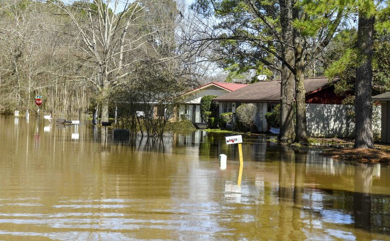 Water floods the street of Canton Club Circle subdivision on Saturday in northeast Jackson, Miss.