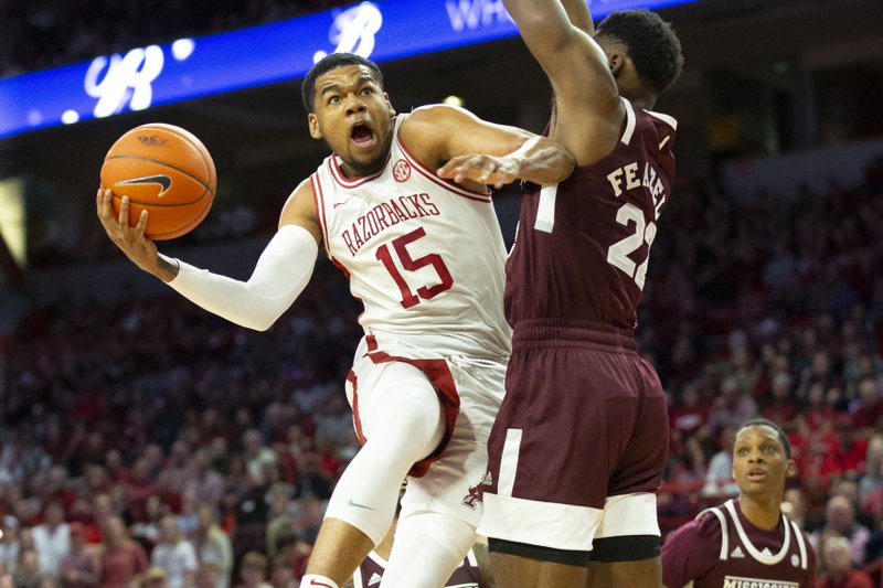 Mississippi State vs University of Arkansas - Arkansas Junior Mason Jones (15) goes up for a layup, and got foulded by Mississippi State's KeyShawn Feazell (22) at Bud Walton Arena, Fayetteville, on February 15,2019.