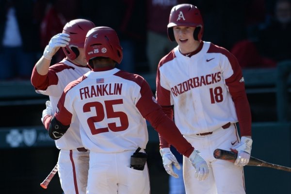 Arkansas outfielder Christian Franklin is greeted by Razorbacks teammates after hitting a home run on Friday, Feb. 14, 2020 during the team's season opener against Eastern Illinois at Baum-Walker Stadium in Fayetteville. Visit nwaonline.com/200214Daily/ for today's photo gallery.