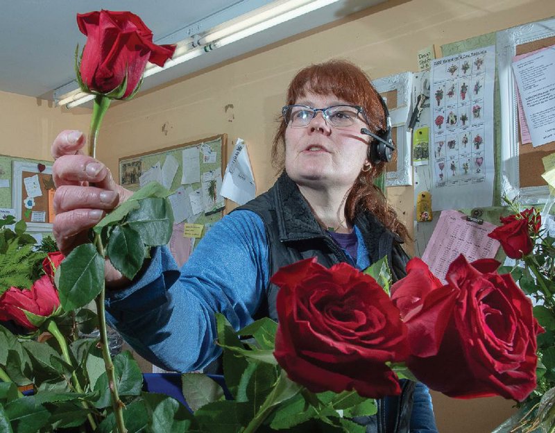 Flower shop owner Billie Jo Brito in Lewiston, Maine, gets ready earlier this week for Valentine’s Day sales. Retail sales for December were revised downwardly to a 0.2% increase, the Commerce Department said Friday.
(AP/Sun Journal/Russ Dillingham)