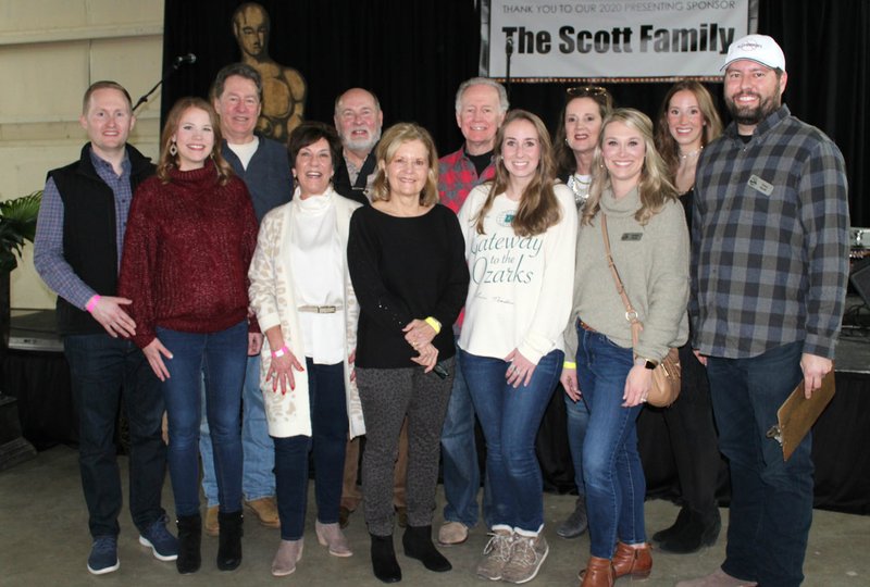 The Scott family (from left), Zeb and Quincy Scott, Tom Scott, Karla and Phillip Scott, Gale Scott, Mike Scott, McKenna Scott, Anita Scott, Amber Scott, Micah Scott and Corey Scott, welcome guests to the 15th and final Chilirhea fundraiser Feb. 8 at the Washington County Fairgrounds in Fayetteville. (NWA Democrat-Gazette/Carin Schoppmeyer)