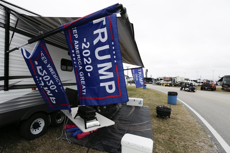 Flags supporting President Donald Trump fly in the infield days before his appearance at the NASCAR Daytona 500 auto race at Daytona International Speedway, Friday, Feb. 14, 2020, in Daytona Beach, Fla. Trump will find Daytona International Speedway as welcoming as one of his campaign rallies. (AP Photo/John Raoux)