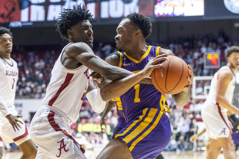 Alabama guard Kira Lewis Jr. (2) defends as LSU guard Javonte Smart (1) attacks during the first half of an NCAA college basketball game, Saturday, Feb. 15, 2020, in Tuscaloosa, Ala. (AP Photo/Vasha Hunt)