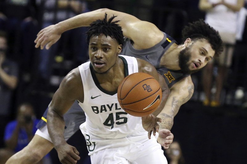 Baylor guard Davion Mitchell, left, breaks away from West Virginia guard Jermaine Haley for a fast break in the second half of an NCAA college basketball game, Saturday, Feb. 15, 2020, in Waco, Texas. (AP Photo/Rod Aydelotte)