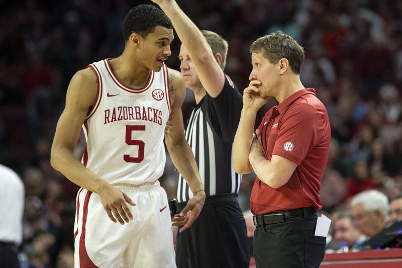 Arkansas Junior Jalen Harris (5) talking to coach Eric Musselman during at time out against Mississippi State,
at Bud Walton Arena, Fayetteville, on February 15,2020