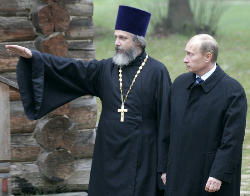 Russian President Vladimir Putin walks through Butovo, outside Moscow, in 2007 with Kirill Kaleda, a Russian Orthodox priest whose grandfather was among 20,000 put to death there during Josef Stalin’s “Great Terror” of 1937-38. “We need to know the truth,” the priest said recently.
(AP file photo)