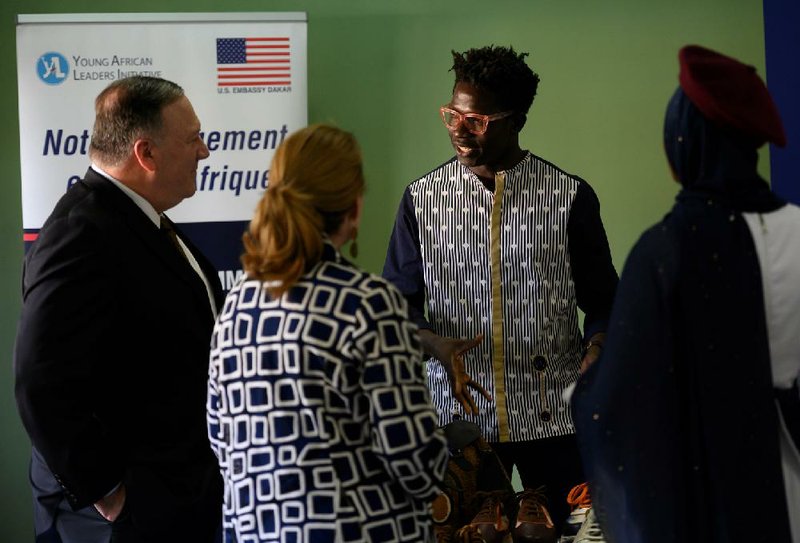 Secretary of State Mike Pompeo (left) and his wife Susan on Sunday talk with an entrepreneur in Dakar, Senegal, who received assistance from a U.S. government program. More photos at arkansasonline.com/217pompeo/.
 (Andrew Carballero-Reynolds/AP)