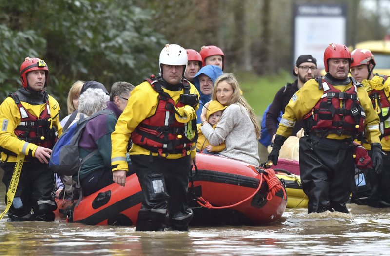 Rescue operations continue as emergency services take residents to safety Sunday in Nantgarw, Wales. Storm Dennis is roaring across Britain with high winds and heavy rains, prompting authorities to issue 350 flood warnings, including a "red warning" alert for life-threatening flooding in south Wales. - Ben Birchall/PA via AP