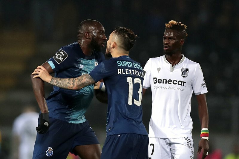 Porto's Moussa Marega, from Mali, left, leaves the pitch during a Portuguese league soccer match between Vitoria SC and FC Porto in Guimaraes, Portugal, Sunday, Feb. 15, 2020. The president and the prime minister of Portugal have added their voices to a national outcry over racist abuse aimed at Moussa Marega who walked off the field after hearing monkey chants. (AP Photo)
