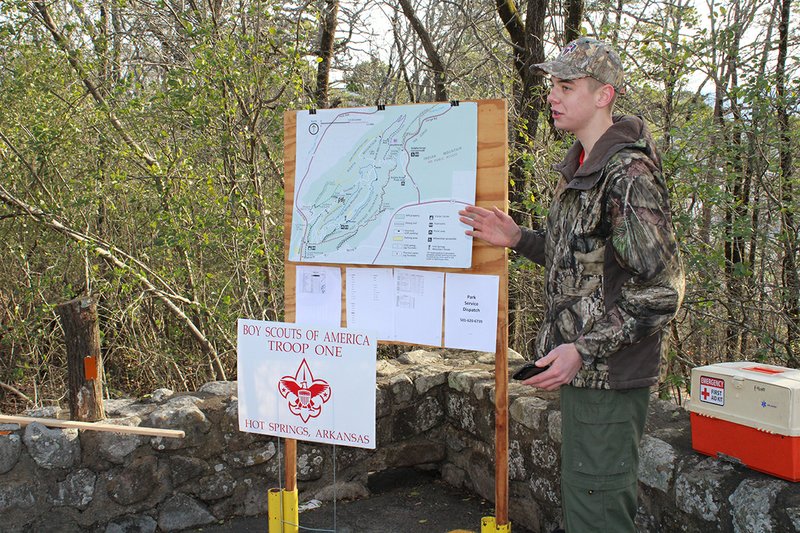 Troop One Boy Scout Aaron Humphrey shows a map of trails in Hot Springs National Park on Saturday. Humphrey and a group of volunteers have installed 800 trail markers on the trails over the past month as his Eagle Scout Project. - Photo by Tanner Newton of The Sentinel-Record