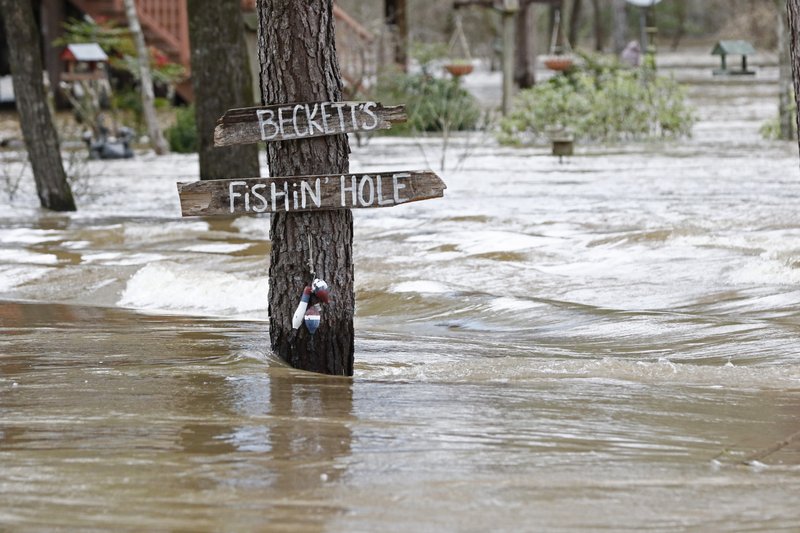 The Associated Press FLOODS: Water from the Pearl River floods Florence-Byram Road near Byram, Miss, Monday. Authorities believe the flooding will rank as third highest, behind the historic floods of 1979 and 1983.