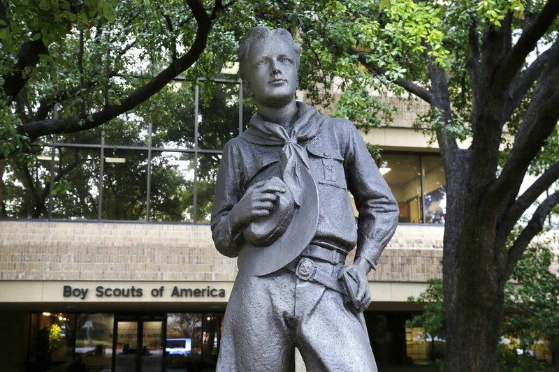 In this Wednesday, Feb. 12, 2020, photo, a statue stands outside the Boys Scouts of America headquarters in Irving, Texas. The Boy Scouts of America has filed for bankruptcy protection as it faces a barrage of new sex-abuse lawsuits. The filing Tuesday, Feb. 18, in Wilmington, Delaware, is an attempt to work out a potentially mammoth compensation plan for abuse victims that will allow the 110-year-old organization to carry on. (AP Photo/LM Otero)