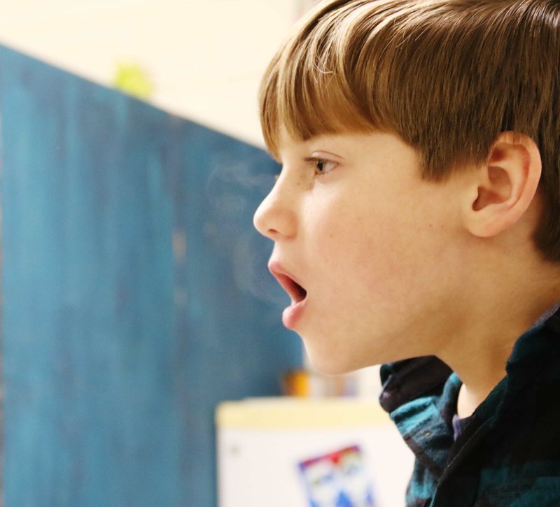 Chanler Rogers, a 3rd grader at Yocum Elementary School and a student with the Gifted and Talented program, releases vapor from his mouth Feb. 11. Students from across the district are tested for the program in 1st grade.      