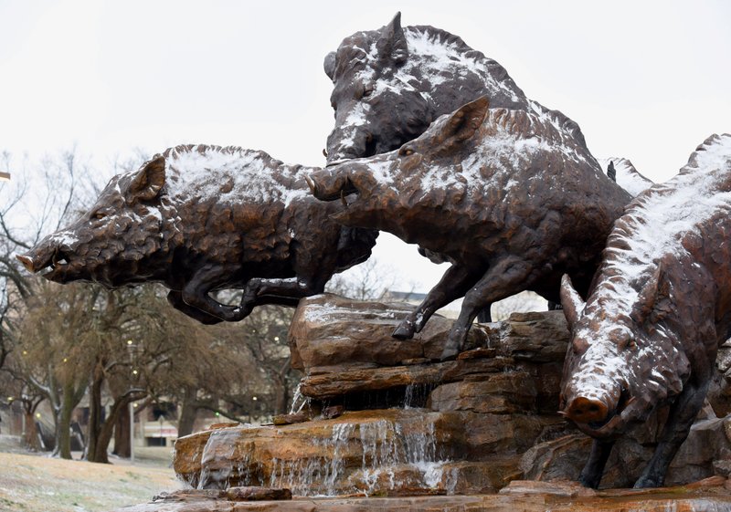 In this Feb. 2020 file photo, a light dusting of snow is visible on the Wild Band of Razorbacks monument on the northeast corner of Donald W. Reynolds Razorback Stadium on the campus of the University of Arkansas in Fayetteville.