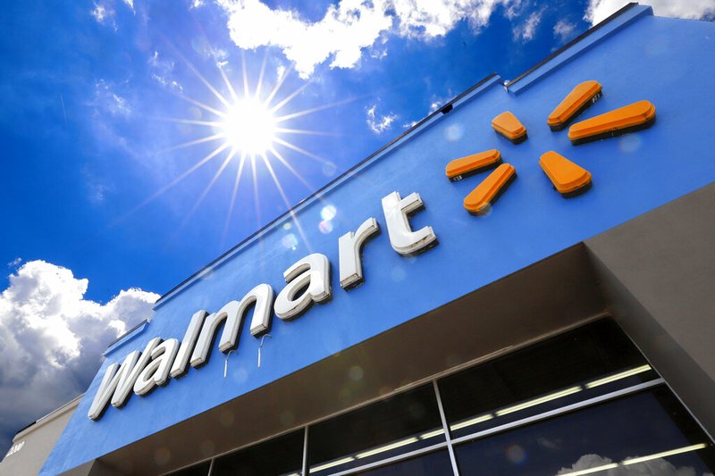 FILE - This June 25, 2019, file photo shows the entrance to a Walmart in Pittsburgh. Walmart is reporting disappointing fourth-quarter profits and sales. The nation's largest retailer says that sales at its U.S. stores heading into the holiday season were weaker than expected. It also said that social unrest in Chile hurt its business. 