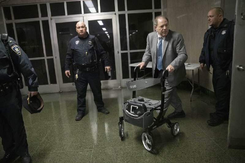 Harvey Weinstein (using walker) leaves a New York City courthouse Tuesday, the first day of jury deliberations in his rape trial. More photos at arkansasonline.com/219weinstein/.
(AP Photo/Mary Altaffer)