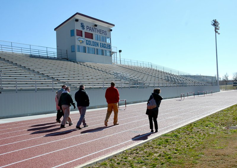 Janelle Jessen/Herald-Leader School board members walked around the updated track at the Siloam Springs Middle School with Superintendent Jody Wiggins during a tour on Thursday. The school district and John Brown University partnered to remodel the track facility. The track surface is complete and there are only a few pieces of the project, such as fencing and bathrooms, left to finish, Shane Patrick, director of operations, reported at Thursday's school board meeting.