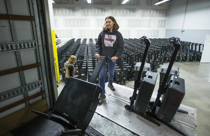 Julie Hall with the Benton County Election Commission loads voting machines Thursday into a truck at the Benton County Election Commission office in Rogers. Staff began distributing equipment Thursday to the 36 vote centers for the March 3 primary election. Go to nwaonline.com/200214Daily/ for today's photo gallery. (NWA Democrat-Gazette/Ben Goff)