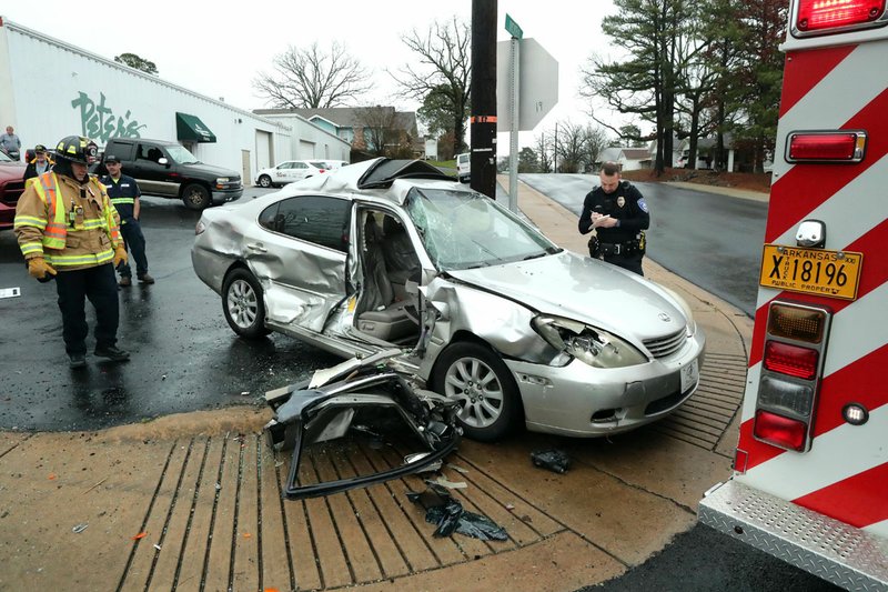Emergency personnel work the scene of a two-vehicle wreck that occurred around 9:30 a.m. Tuesday at the intersection of Malvern Avenue and Nickels Street. - Photo by Richard Rasmussen of The Sentinel-Record