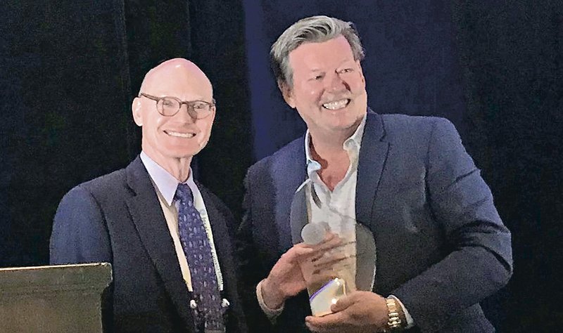 Arkansas Democrat Gazette publisher Walter E. Hussman Jr. (left) accepts the Mega-Innovation Award from Dave Kennedy, the chief revenue officer for the Honolulu Star-Advertiser. The Democrat-Gazette was honored for its iPad initiative at the Key Executives Mega-Conference in Fort Worth on Tuesday.
(Arkansas Democrat-Gazette/Barry Arthur)