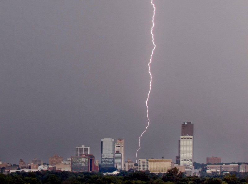 Lightning strikes behind the skyline of Little Rock in this 2011 file photo.