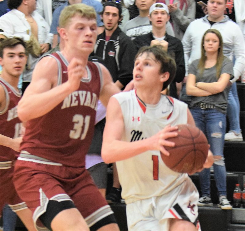 RICK PECK/SPECIAL TO MCDONALD COUNTY PRESS McDonald County's 5-8 Pierce Harmon drives past Nevada's 6-6 Dalton Gayman during the Mustangs' 70-44 loss on Feb. 14 at MCHS.