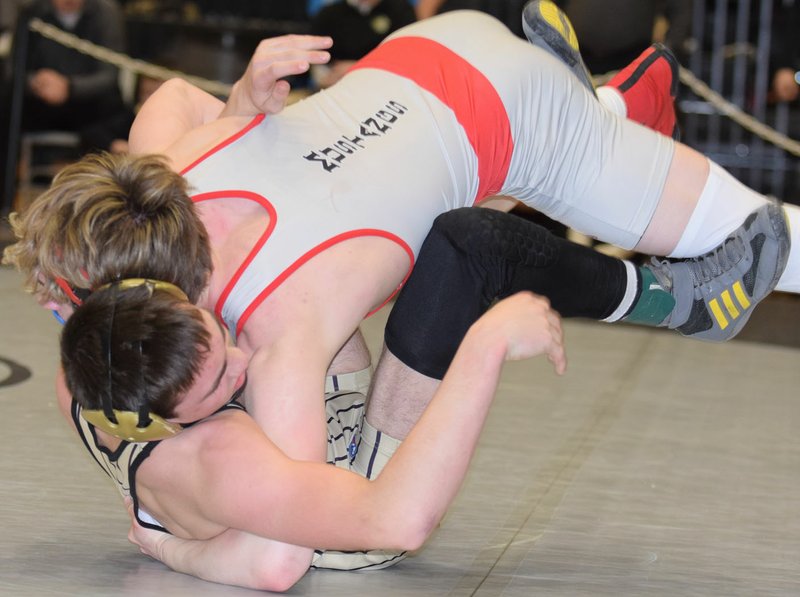 RICK PECK/SPECIAL TO MCDONALD COUNTY PRESS McDonald County's Oscar Ortiz lands on top of Neosho's Kolton Sanders on the way to winning the 132-pound title at the MSHSAA Class 3, District 3, Wrestling Tournament on Feb. 15 at Willard High School.