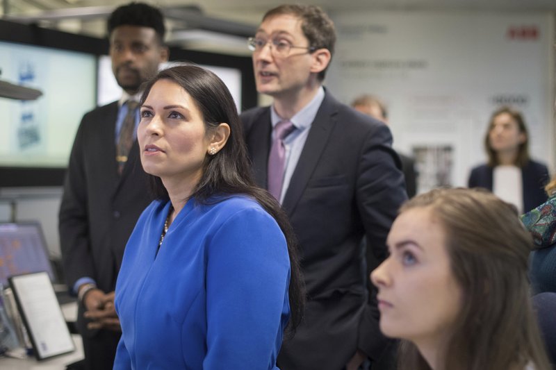 Britain's Home Secretary Priti Patel meets students and staff working on 'carbon capture' at Imperial College London in South Kensington, London, on Tuesday. Britain has announced a new post-Brexit "points-based immigration system" said Patel, that will assess prospective immigrants on a range of skills, qualifications, salaries or professions, starting next year. - Stefan Rousseau/PA via AP