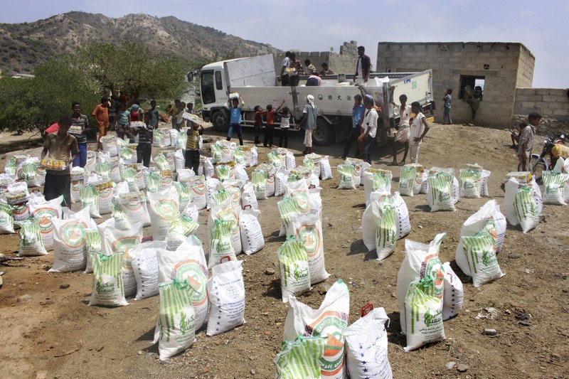 In this Sept. 23, 2018 file photo, men deliver aid donations from donors, in Aslam, Hajjah, Yemen.  (AP Photo/Hammadi Issa, File)