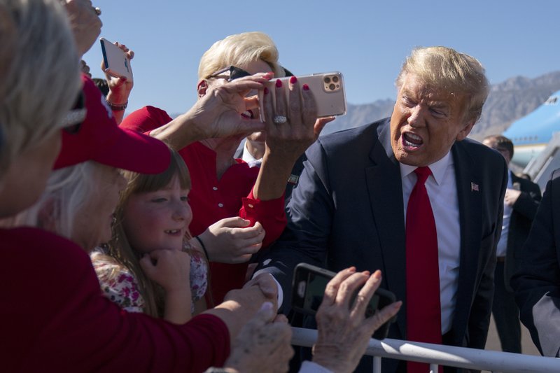 President Donald Trump greets supporters after arriving at Palm Springs International Airport to attend a fundraiser in Rancho Mirage, Calif., Wednesday, Feb. 19, 2020, in Palm Springs, Calif. (AP Photo/Evan Vucci)